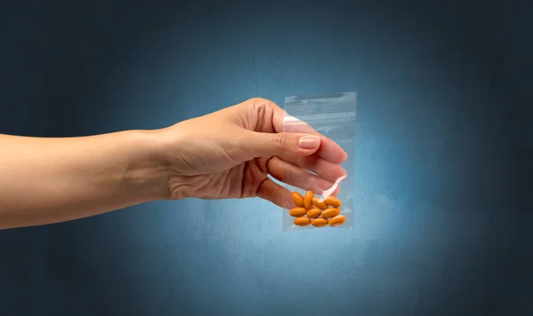 Giving drugs in plastic bag — Stock Photo, Image