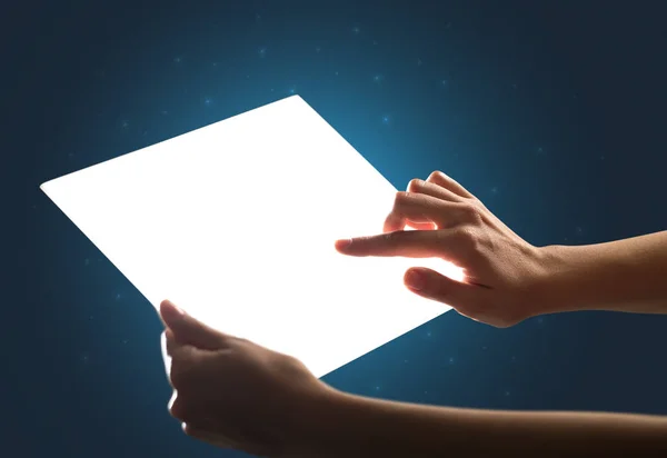 Hands touching a glass-like tablet — Stock Photo, Image