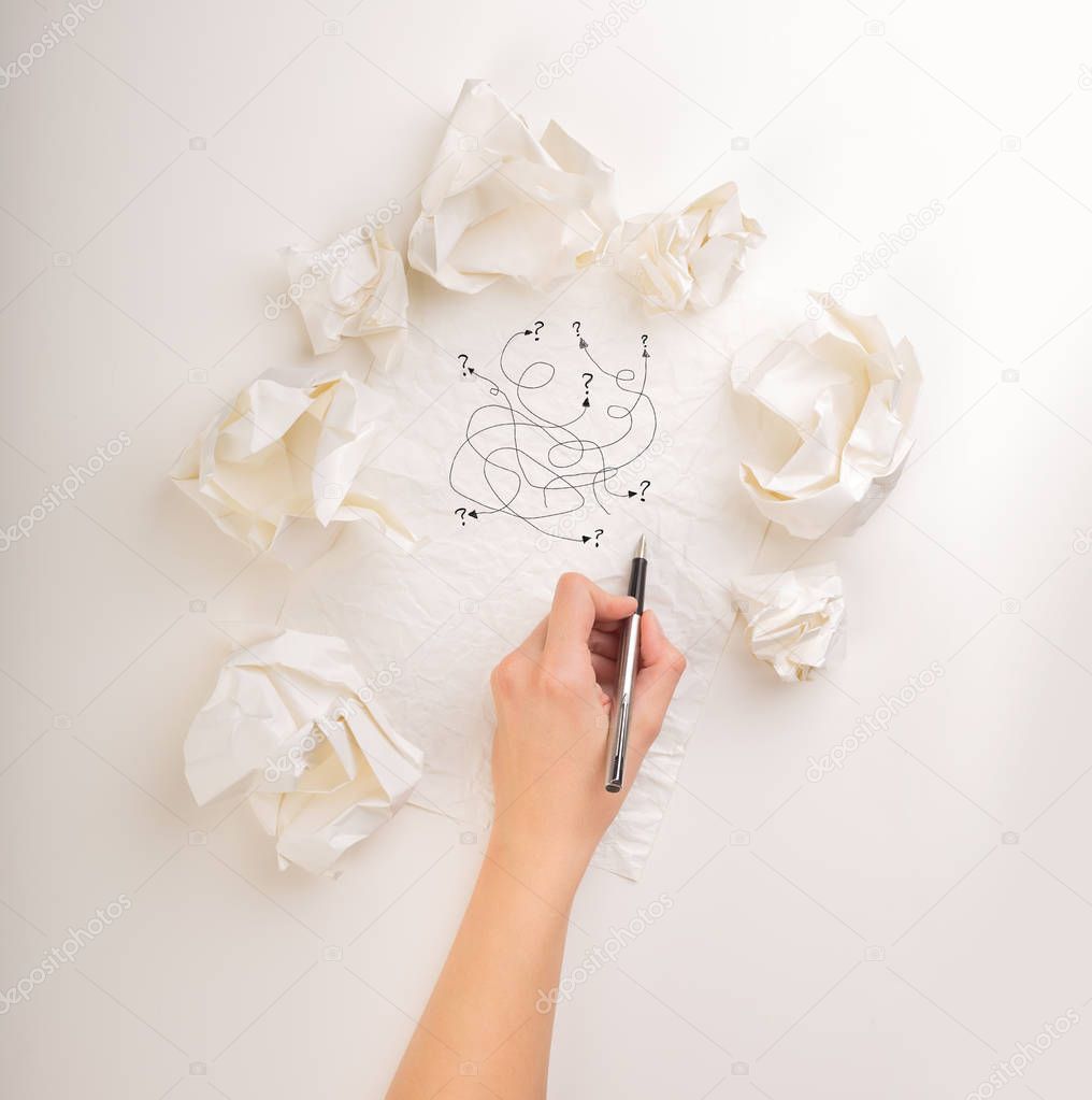 Writing hand in crumpled paper