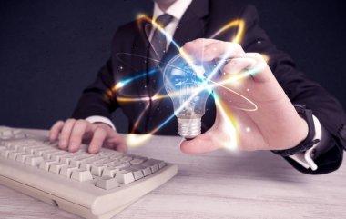 renkli bir ampul tutan işadamı