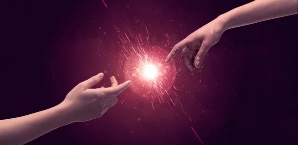 Touching hands light up sparkle in space