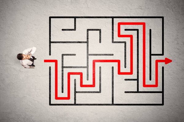 Lost businessman found the way in maze with red arrow