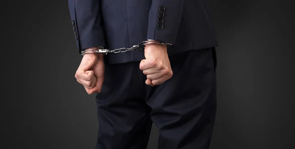 Dark backgrounded close handcuffed man — Stock Photo, Image
