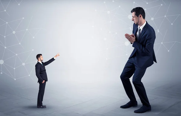 Small man aiming at a big man with network concept — Stock Photo, Image