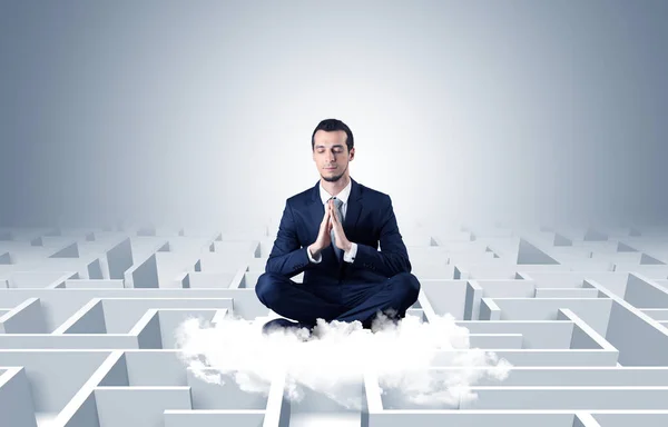 Businessman meditates on a cloud with maze concept — Stock Photo, Image