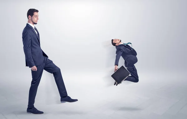 Small man fired by boss with white wallpaper — Stock Photo, Image