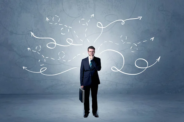 Businessman standing with winding arrows around — Stock Photo, Image