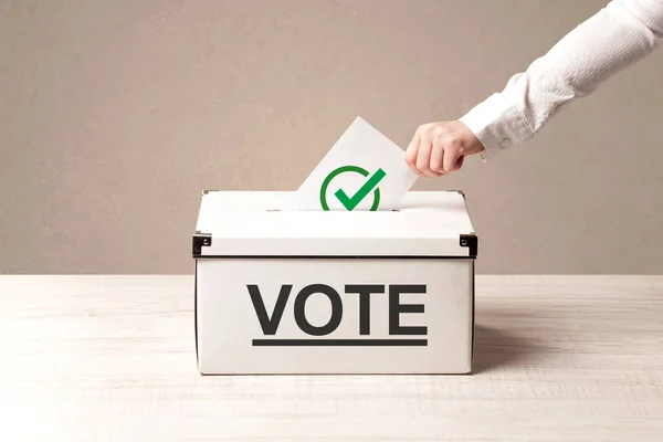 Close up of male hand putting vote into a ballot box — Stock Photo, Image