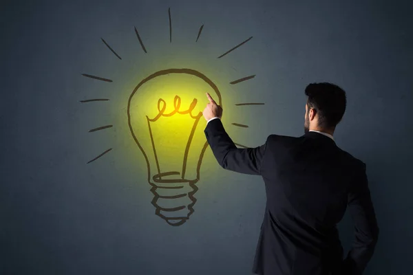 Businessman with lightbulb — Stock Photo, Image