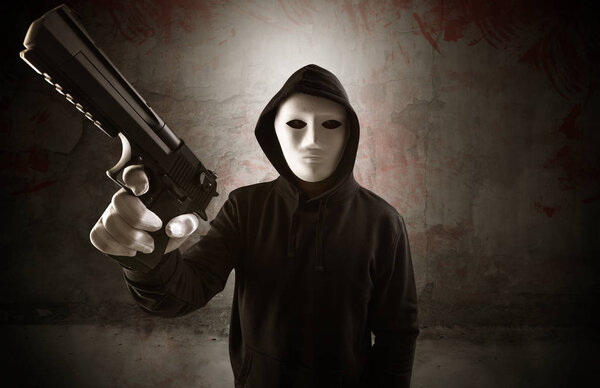 Armed assassin in an empty bloody room concept