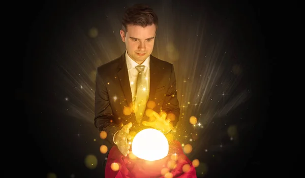 Businessman  sitting with sparkling magic ball — Stock Photo, Image