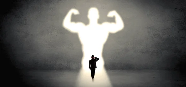 Businessman standing in front of a strong hero vision — Stock Photo, Image