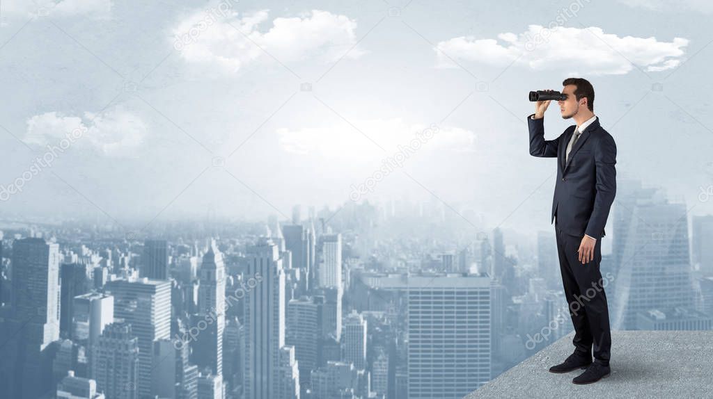 Man looking forward from the top of a skyscraper