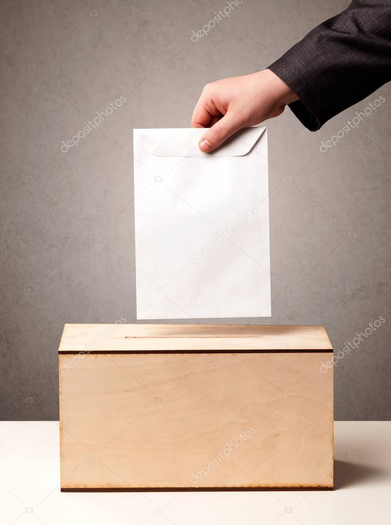 Ballot box with person casting vote 