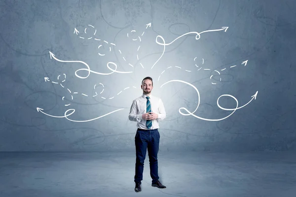 Businessman standing with winding arrows around — Stock Photo, Image