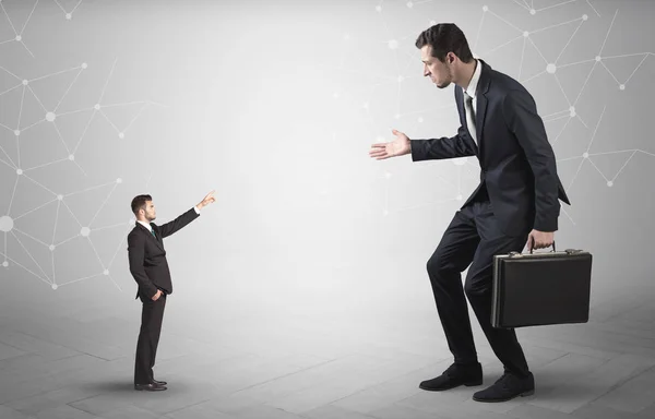 Small man aiming at a big man with network concept — Stock Photo, Image