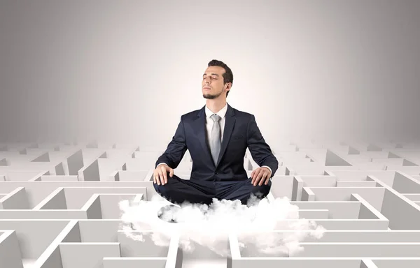 Businessman meditates on a cloud with maze concept — Stock Photo, Image