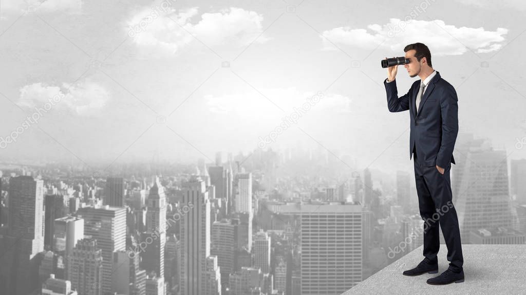 Man looking forward from the top of a skyscraper