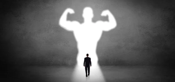 Businessman standing in front of a strong hero vision — Stock Photo, Image