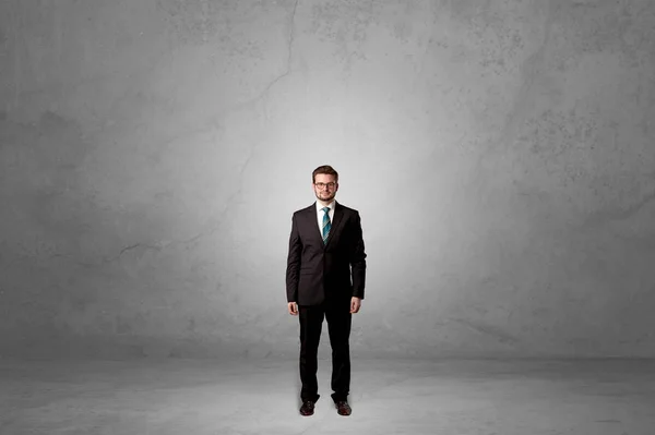 Alone businessman standing in a dark room — Stock Photo, Image