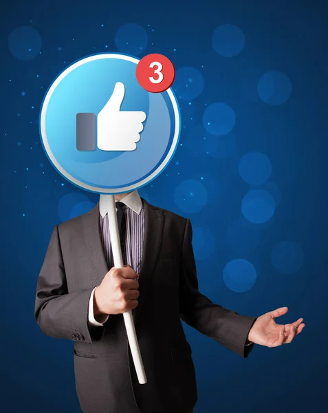 Businessman holding facebook sign — Stock Photo, Image