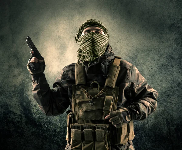 Porträtt av en tungt beväpnade maskerade soldat med grungy bakgrund — Stockfoto