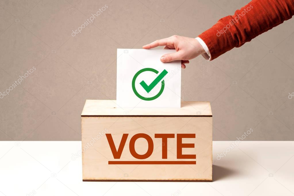 Close up of male hand putting vote into a ballot box