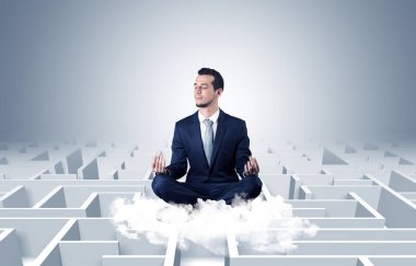 Businessman meditates on a cloud with maze concept clipart