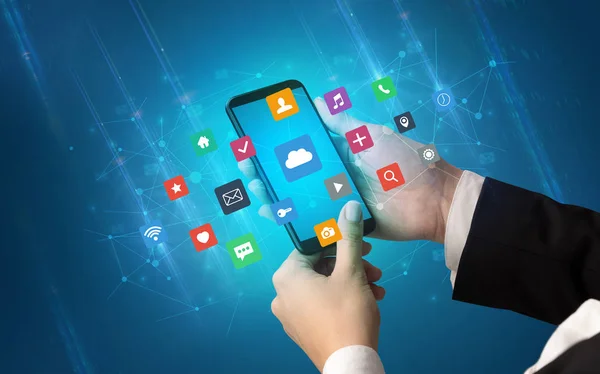 Hand using smartphone with application icons — Stock Photo, Image