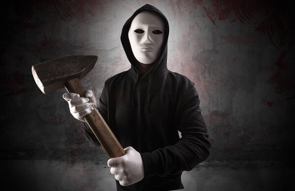 Armed assassin in an empty bloody room concept