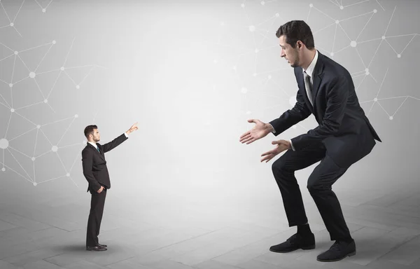 Small man aiming at a big man with network concept — Stock Photo, Image