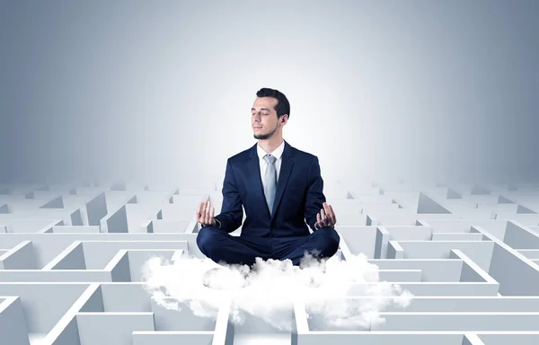 Businessman meditates on a cloud with maze concept — Stock Photo, Image