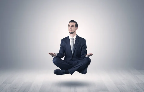 Businessman meditates in an empty space concept — Stock Photo, Image