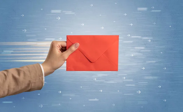 Hand holding envelope with arrows around — Stock Photo, Image