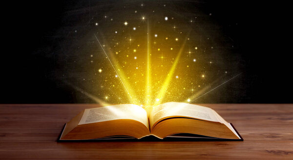 Yellow lights and sparkles coming from an open book