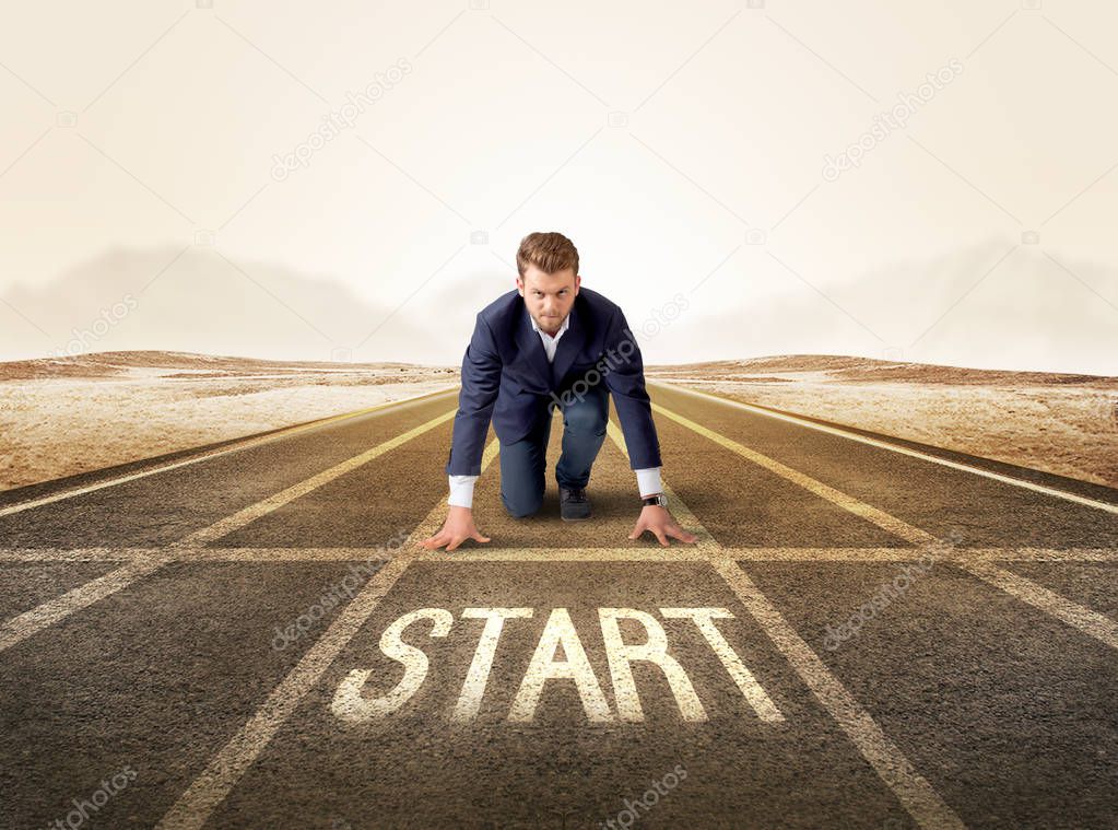 Businessman kneeling in ready position