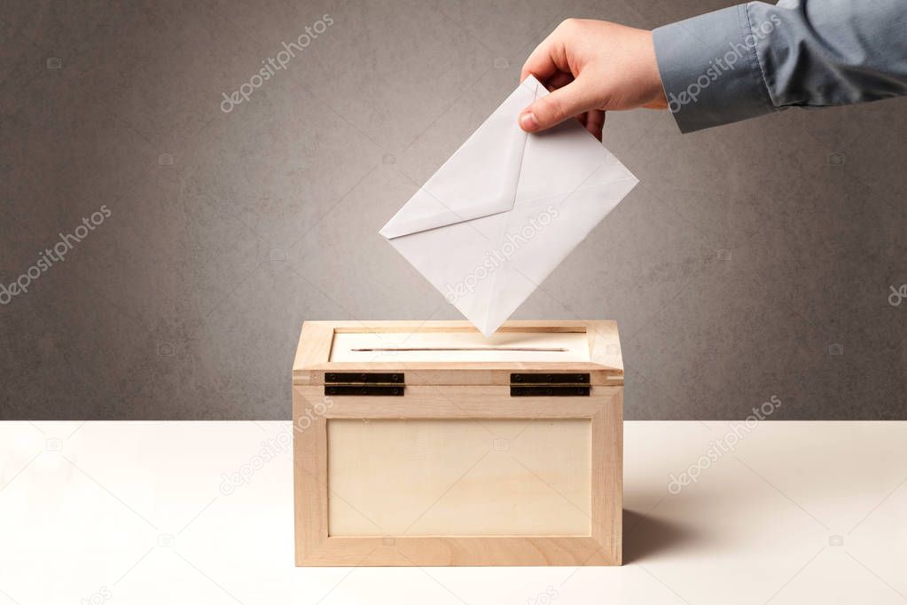 Ballot box with person casting vote 