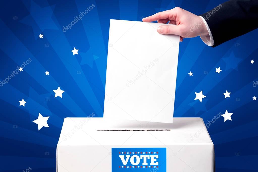 hand with ballot and wooden box