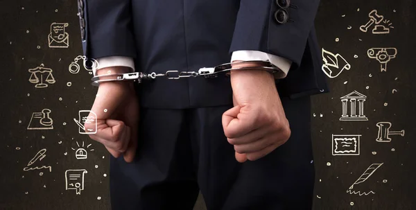 Symbols of courthouse with handcuffed man — Stock Photo, Image