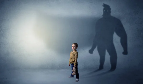 Cute kid with hero shadow behind — Stock Photo, Image