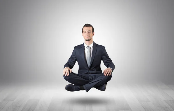 Businessman meditates in an empty space concept — Stock Photo, Image