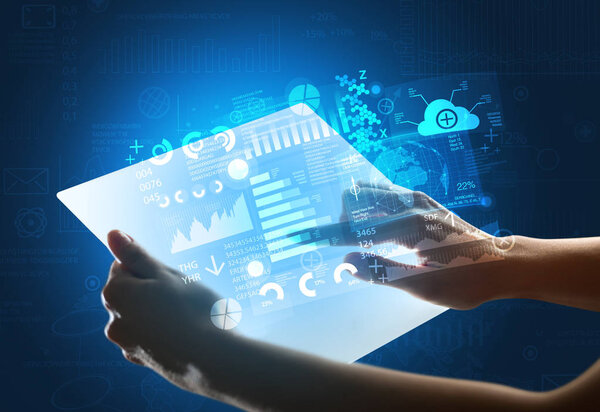 Hands touching a glass-like tablet with blue graphs