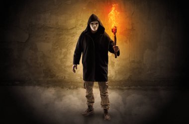 Wayfarer with burning torch in front of crumbly wall concept clipart