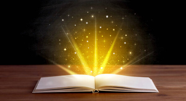 Yellow lights and sparkles coming from an open book