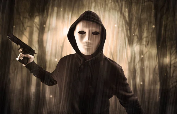 Armed hitman in dark nocturnal forest concept — Stock Photo, Image