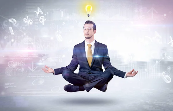 Zakenman mediteert met verlichting concept — Stockfoto