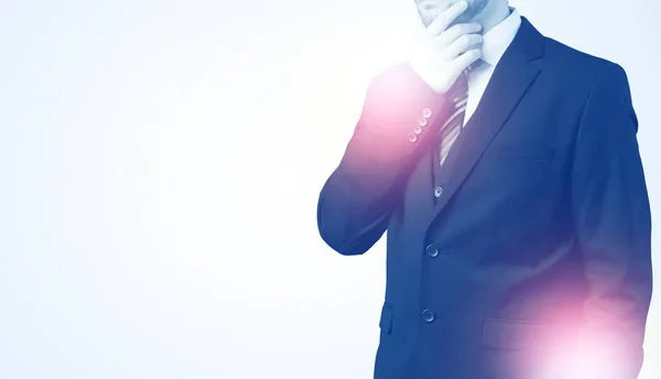 Young businessman standing and thinking — Stock Photo, Image