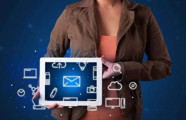 Woman holding tablet with media graphics — Stock Photo, Image