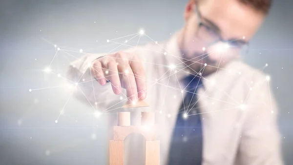 Businessman building a tower — Stock Photo, Image