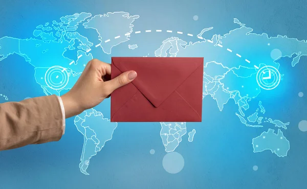 Hand holding envelope with global concept